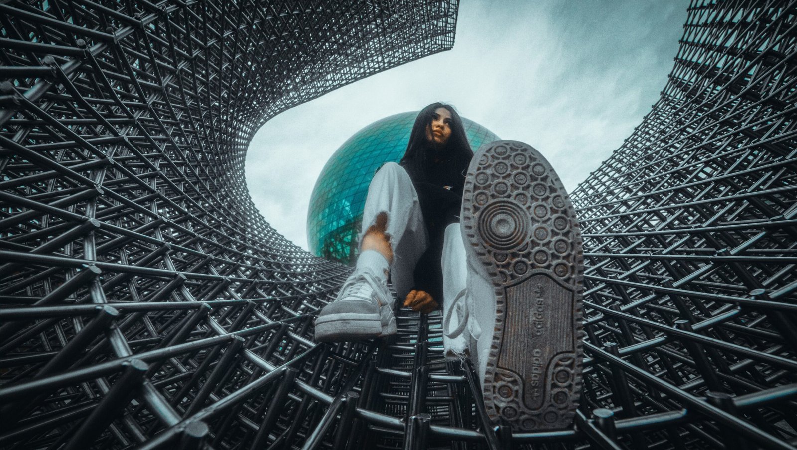 A person sitting in a large metal structure