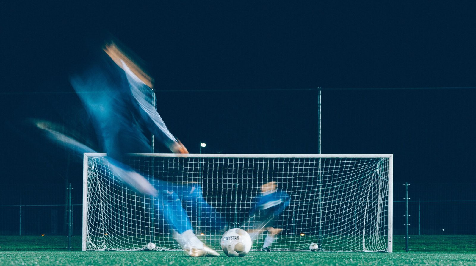 timelapse photo of soccer player kicking ball