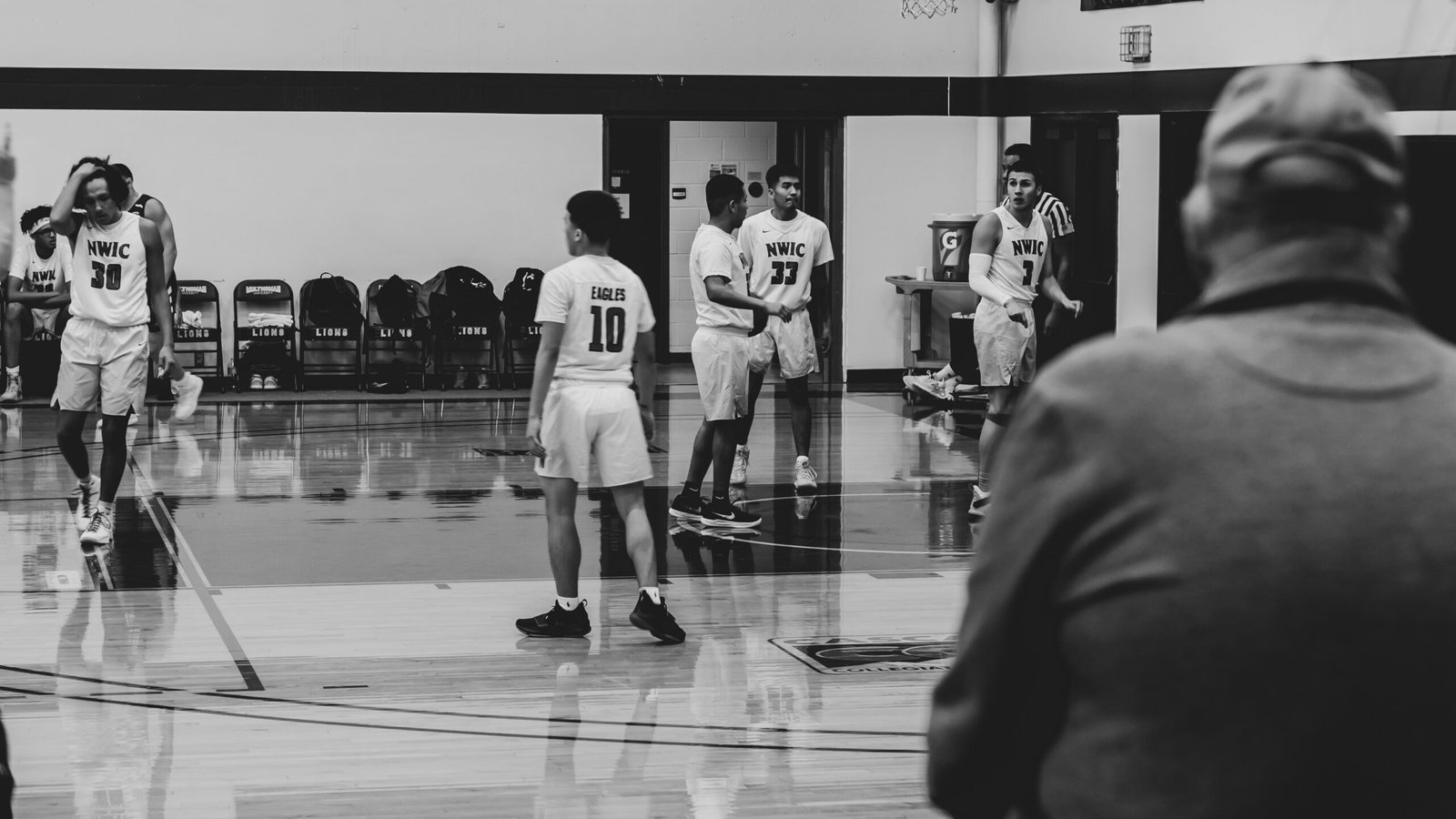 grayscale photography of players inside court