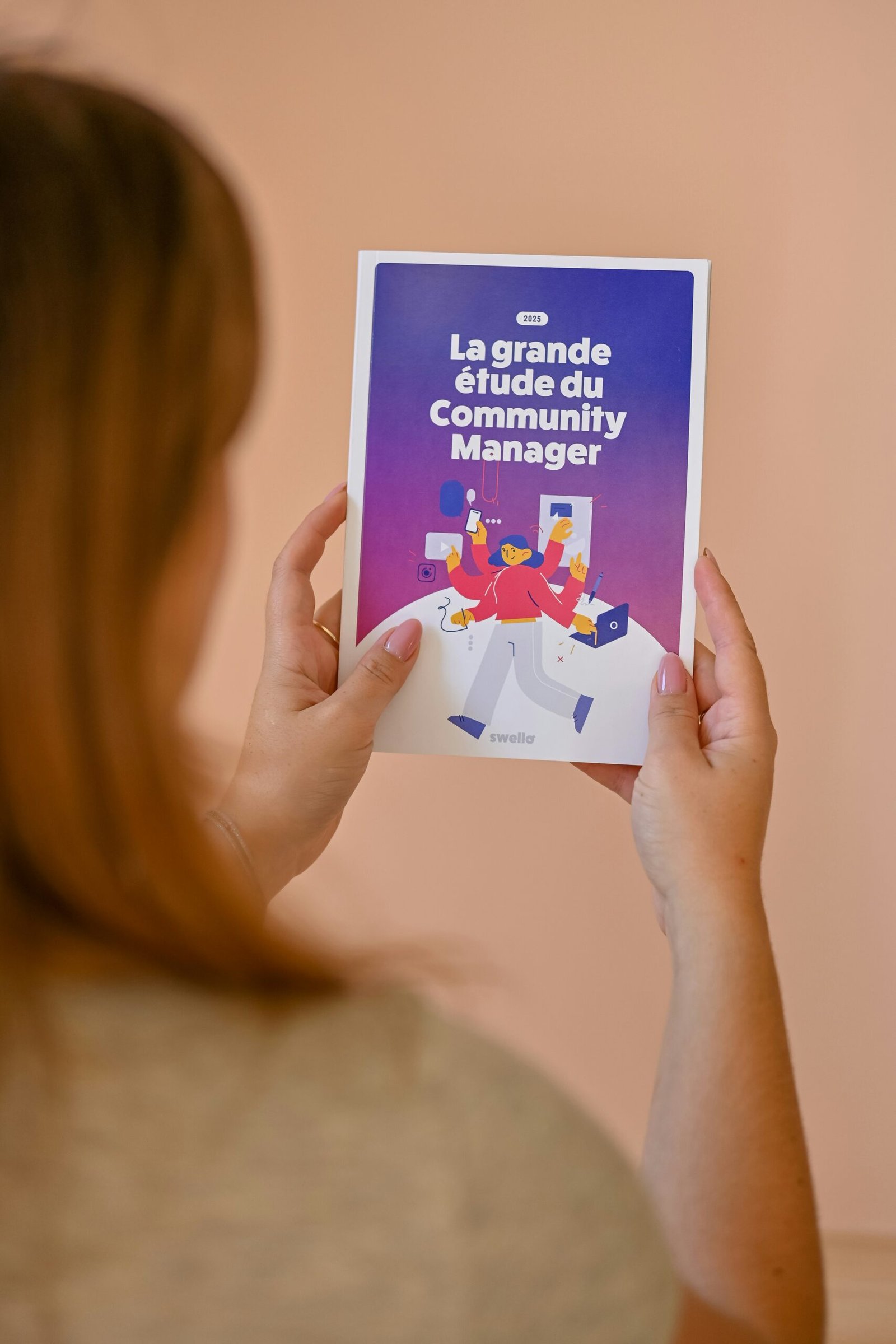 Woman holding a booklet about community management.